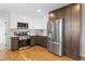 Well-lit kitchen with stainless steel appliances, two-tone cabinets, and neutral backsplash at 30484 Chisholm Trl, Elizabeth, CO 80107