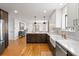 Open kitchen layout featuring two-tone cabinetry, stainless appliances, white countertops, and hardwood floors at 30484 Chisholm Trl, Elizabeth, CO 80107