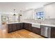 Modern kitchen with two-tone cabinetry, stainless steel appliances, white countertops, and farmhouse sink at 30484 Chisholm Trl, Elizabeth, CO 80107