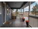 Inviting covered porch with rocking chairs and scenic views of the surrounding landscape at 30484 Chisholm Trl, Elizabeth, CO 80107