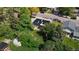 An aerial view of a home with solar panels on the roof in a lush neighborhood at 11718 Keough Dr, Northglenn, CO 80233