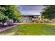 View of the backyard featuring a lawn, patio, and deck with stairs at 11718 Keough Dr, Northglenn, CO 80233