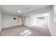 Expansive basement featuring neutral carpeting, egress window, and versatile open space at 11718 Keough Dr, Northglenn, CO 80233