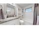 Well-lit bathroom features a granite countertop vanity, updated fixtures, and a bathtub with tiled shower at 11718 Keough Dr, Northglenn, CO 80233