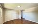 Bedroom featuring hardwood floors, closet with sliding doors, and access to other rooms at 11718 Keough Dr, Northglenn, CO 80233