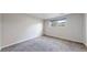 Bright bedroom featuring neutral carpeting and a large window at 11718 Keough Dr, Northglenn, CO 80233