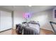 Comfortable bedroom with stylish bed, hardwood flooring, and contemporary lighting accents at 11718 Keough Dr, Northglenn, CO 80233