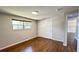 Bedroom features hardwood floors, a closet with sliding doors, and a window for natural light at 11718 Keough Dr, Northglenn, CO 80233