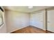 Bedroom with hardwood floors, neutral paint, closet, and natural light from a window at 11718 Keough Dr, Northglenn, CO 80233