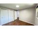 Bedroom with hardwood floors, closet with sliding doors, and access to other rooms at 11718 Keough Dr, Northglenn, CO 80233