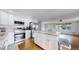 Beautiful kitchen featuring white cabinetry, stainless steel appliances, and a granite island at 11718 Keough Dr, Northglenn, CO 80233