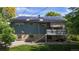 This is the rear exterior of a two story home with a deck and solar panels at 11718 Keough Dr, Northglenn, CO 80233
