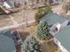 Aerial view of the home, highlighting its deck, mature trees, green roof, and prime location in a quiet neighborhood at 2573 S Troy Ct, Aurora, CO 80014