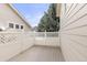 Back deck area with white wood lattice privacy fence and large pine tree behind at 2573 S Troy Ct, Aurora, CO 80014