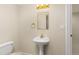 Cozy bathroom featuring pedestal sink, and plenty of space with a decorative mirror at 2573 S Troy Ct, Aurora, CO 80014