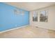 Bedroom featuring lots of natural light and a bright blue accent wall at 2573 S Troy Ct, Aurora, CO 80014