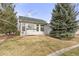 Charming home featuring large windows that let in an abundance of light and a perfectly manicured lawn at 2573 S Troy Ct, Aurora, CO 80014
