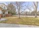 The front lawn offers plenty of space for outdoor activities and the mature trees provide shade at 2573 S Troy Ct, Aurora, CO 80014