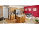 Spacious kitchen with wood cabinets, granite countertops, island, stainless steel refrigerator, and dining area at 2573 S Troy Ct, Aurora, CO 80014
