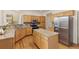 Kitchen featuring wood cabinets, stainless appliances, granite countertops and a center island with bar seating at 2573 S Troy Ct, Aurora, CO 80014