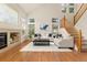 Open living area boasts high ceilings, a cozy fireplace, and staircase access to the upper level at 2573 S Troy Ct, Aurora, CO 80014