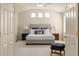 Main bedroom featuring a vaulted ceiling, neutral color palette, lamps, and a cushioned bench at 2573 S Troy Ct, Aurora, CO 80014