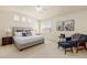 Spacious main bedroom featuring a neutral color palette and sitting area by the window at 2573 S Troy Ct, Aurora, CO 80014