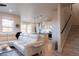 Open-concept living area featuring a sleek kitchen, a plush white sofa, and a staircase at 11560 Dewey St, Parker, CO 80138