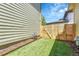 Low maintenance backyard space with artificial turf and a wooden privacy fence at 1903 W 66Th Ave, Denver, CO 80221