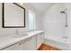 Bathroom featuring a tiled shower-tub combo and a single-sink vanity with drawers at 1903 W 66Th Ave, Denver, CO 80221