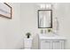 Bright half bathroom with a modern sink vanity and toilet at 1903 W 66Th Ave, Denver, CO 80221