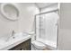 Bathroom featuring a glass door shower and vanity with storage at 1903 W 66Th Ave, Denver, CO 80221