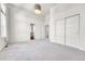 Bright bedroom with neutral carpet, white walls, and double door closet storage at 1903 W 66Th Ave, Denver, CO 80221