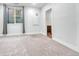 Bedroom with a window, gray carpet, and a view into an adjacent bathroom at 1903 W 66Th Ave, Denver, CO 80221