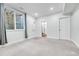 Bedroom featuring gray carpet, a window, and access to an adjacent bathroom at 1903 W 66Th Ave, Denver, CO 80221