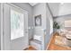 Bright foyer with bench seating, hardwood floors, and view into living space at 1903 W 66Th Ave, Denver, CO 80221