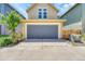 View of the garage on a sunny day with a long driveway for multiple cars at 1903 W 66Th Ave, Denver, CO 80221