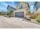 Attached two car garage with a large driveway and low-maintenance landscaping at 1903 W 66Th Ave, Denver, CO 80221