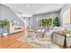 Bright and airy living room featuring hardwood floors, neutral tones, and a cozy seating area at 1903 W 66Th Ave, Denver, CO 80221