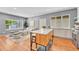 Open living space with an island with seating, wood floors, large window and gray paint at 1903 W 66Th Ave, Denver, CO 80221