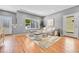 Bright living room featuring hardwood floors, neutral tones, and a large picture window at 1903 W 66Th Ave, Denver, CO 80221
