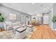 Open-concept living area with hardwood floors, neutral tones, and modern furnishings at 1903 W 66Th Ave, Denver, CO 80221