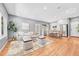 Open-concept living area with hardwood floors, neutral tones, and modern furnishings at 1903 W 66Th Ave, Denver, CO 80221
