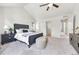 Bright main bedroom boasts vaulted ceiling, neutral carpeting, and stylish furniture at 1903 W 66Th Ave, Denver, CO 80221