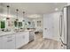 Kitchen featuring white cabinetry, stainless steel appliances, and an open layout leading to the dining area at 1308 Snowberry Ln # 302, Louisville, CO 80027