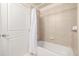 Clean bathroom with a shower-tub combination, white tile, and built-in shelving at 1700 Bassett St # 1106, Denver, CO 80202