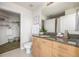 Well-lit bathroom featuring vanity with granite countertop and a walk-in closet for plenty of storage space at 1700 Bassett St # 1106, Denver, CO 80202