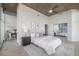 A stylish bedroom with a tufted headboard, mirrored closet doors, and a neutral color palette at 1700 Bassett St # 1106, Denver, CO 80202