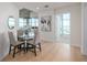 Bright dining area with a glass table and seating for four, adjacent to the living room and a view of the city at 1700 Bassett St # 1106, Denver, CO 80202