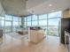Open-concept kitchen and living area with stainless steel appliances, a breakfast bar, and expansive windows offering city views at 1700 Bassett St # 1106, Denver, CO 80202